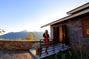 a woman standing on a balcony of a building at Cloud Paradise Resort in Lao Cai