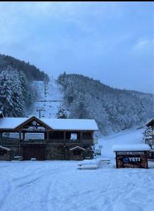 a ski lodge with snow on the ground at Agrifoglio in Torre Caprara