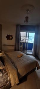 a bedroom with a large bed with a large window at Cozy Flat With Sea View in Tangier +17 photos