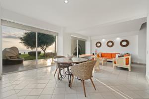 a living room with a table and chairs at Seafront Villa - Puerto Vallarta in Puerto Vallarta