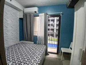 a small bedroom with a bed and a window at Shore 2 Residence Tower 2 in Manila