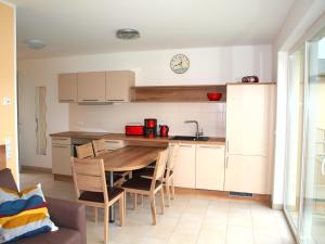a kitchen with a table and chairs in a room at Ferienwohnung Graal Müritz im Igelring in Graal-Müritz +11 photos