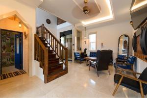 a living room with a staircase and a table and chairs at Gyeongju Sweetcreamhill Pension in Gyeongju