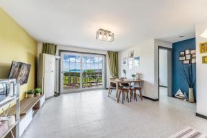 a kitchen and dining room with a table and chairs at Ganghwa Rodemhouse Pension in Incheon