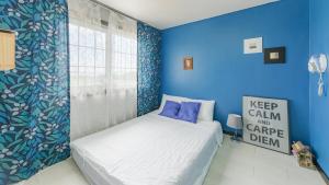 a blue bedroom with a bed and a window at Ganghwa Rodemhouse Pension in Incheon