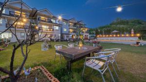 a wooden table and chairs in a yard at night at Ganghwa Rodemhouse Pension in Incheon