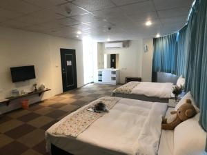 Postel nebo postele na pokoji v ubytování Chang Ti Metropolis Commercial Hotel