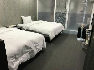 Postel nebo postele na pokoji v ubytování Chang Ti Metropolis Commercial Hotel