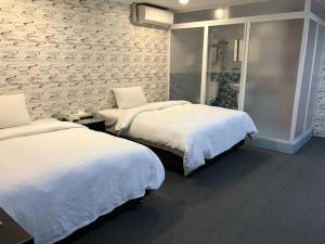Postel nebo postele na pokoji v ubytování Chang Ti Metropolis Commercial Hotel