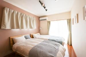 Postel nebo postele na pokoji v ubytování Sakuradai House + 76 fotografií