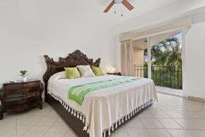 a bedroom with a large bed and a balcony at Seafront Villa - Puerto Vallarta in Puerto Vallarta