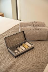 a box of three cigars sitting on a couch at Saladar Suites Boutique in Morro del Jable