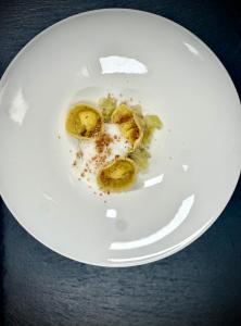 a white plate with some food on a table at Hirben Naturlaub in Villabassa