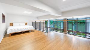 a bedroom with a bed and large glass windows at Gapyeong Sungshine Pension in Gapyeong