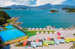 an aerial view of a resort next to a body of water at Goseong Bluebeach Pension&Glamping in Goseong