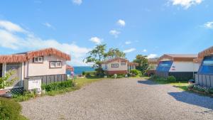 a row of houses with a gravel driveway at Pohang Puleungolae Caravan in Pohang