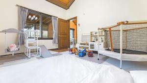 a room with two bunk beds in a room at Namyangju HAIMOM Family Pension Black in Namyangju