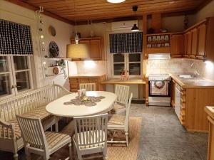a kitchen with a table and chairs in a kitchen at Arctic house in Rovaniemi