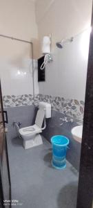 a model of a bathroom with a toilet and a sink at hotel seven beach inn in Mandvi +15 photos