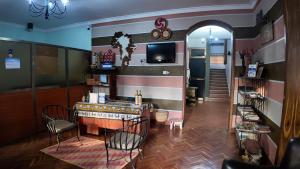 a restaurant with a table and chairs in a room at Korona Villa Lodge in Arusha