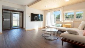 a living room with a couch and a table at Jeju Staysosoheon dokchae pension in Jeju +10 photos