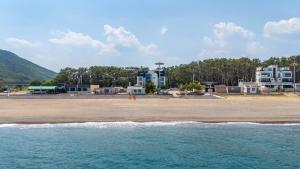 una playa con edificios en el fondo y el océano en Gyeongju Adria Stay Pension, en Gyeongju 7 fotos más