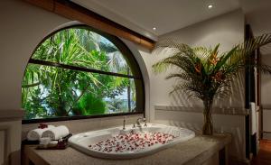 a bathroom with a sink with a large window at PARKROYAL Penang Resort in Batu Ferringhi