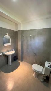a bathroom with a toilet and a sink at Ocean View Guest House in Ahangama