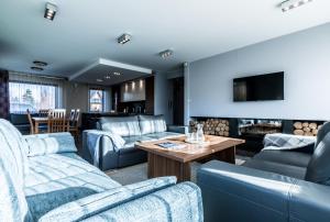 a living room with couches and a table at Villa 64 Zakopane in Zakopane