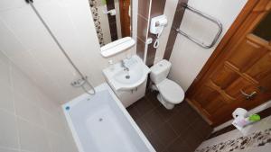a bathroom with a sink and a toilet and a mirror at НОМАД 3-ком Апартаменты в центре in Petropavlovsk