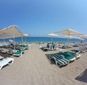 ケメルにあるKaftans City Hotel by RRH&Rのビーチに置かれた椅子とパラソルの群れ