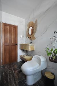 a bathroom with a white toilet and a mirror at Cartagena Hotel Boutique - Manga - Tierra del Mar - Colombia in Cartagena de Indias