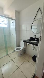 a bathroom with a toilet and a glass shower at Refúgio do Viajante in Espirito Santo Do Pinhal +11 photos