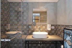 a bathroom with a sink and a mirror at Haifa Peak in Haifa +34 photos