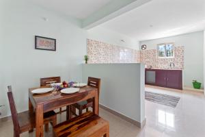 a kitchen and dining room with a table and chairs at BVK Mount Home in Ketti