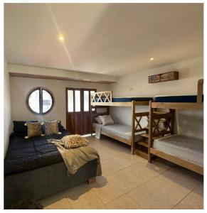 a bedroom with a bed and a bunk bed and a desk at Cartagena Hotel Boutique - Manga - Tierra del Mar - Colombia in Cartagena de Indias