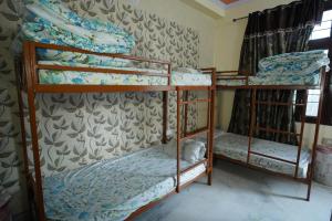 Postel nebo postele na pokoji v ubytování Om Trance Homestay