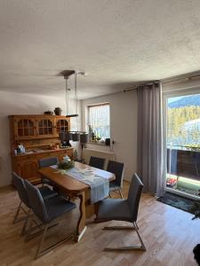 a dining room with a wooden table and chairs at Hotel Bergglück in Filzmoos