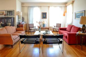 a living room with a red couch and chairs at Aesthetic Delight - Stone Villa in Mystras in Mystras