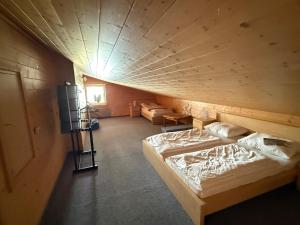 a room with a bed in a wooden room at Hotel Bergglück in Filzmoos