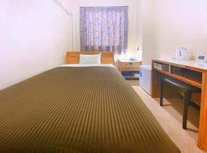 Postel nebo postele na pokoji v ubytování Hotel Okuni (Royal Inn Group)