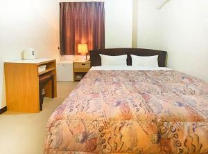 Postel nebo postele na pokoji v ubytování Hotel Okuni (Royal Inn Group)