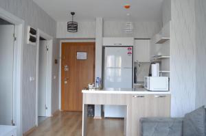 a kitchen with a counter and a white refrigerator at Classic Suite AA7 in Esenyurt