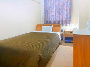 Postel nebo postele na pokoji v ubytování Hotel Okuni (Royal Inn Group)