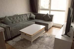 a living room with a couch and a coffee table at Classic Suite AA7 in Esenyurt +10 photos