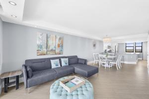 a living room with a couch and a table at Elegant beachfront condo in private community in Marco Island