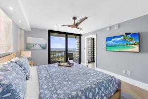 a bedroom with a bed and a large window at Elegant beachfront condo in private community in Marco Island +41 photos