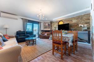a living room with a table and a fireplace at Palm House in Fuengirola