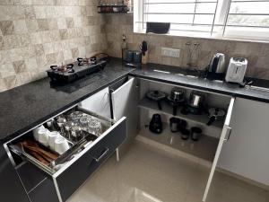 a kitchen with a stove and a counter top at Trinetra Homes 102 in Bangalore