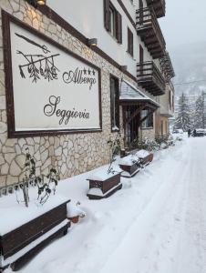a sign on the side of a building in the snow at Albergo Seggiovia in Scanno